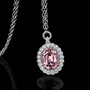 Pink Garnet Pendant Surrounded by  Platinum and Ideal Cut Diamonds.