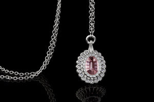 Pink Garnet Pendant Surrounded by  Platinum and Ideal Cut Diamonds.