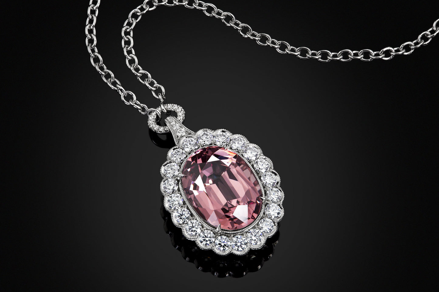 Pink Garnet Pendant Surrounded by  Platinum and Ideal Cut Diamonds.
